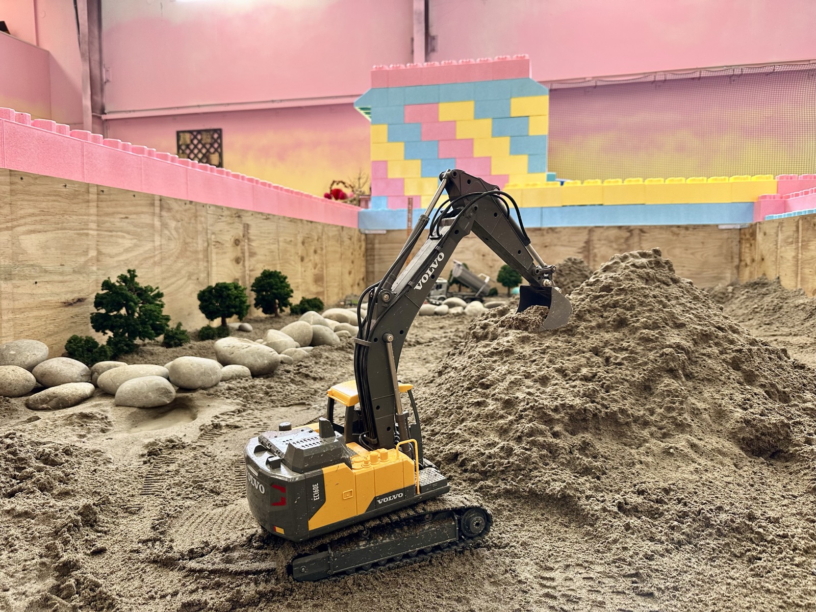 Sandbox with RC Diggers and Dump Trucks